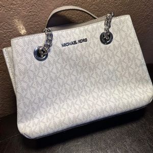 Michael Kors Monogram white Mini Purse. New Condition. 9 in x 7 in. $50